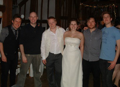 Bride and groom with band