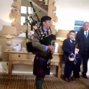 Playing the bagpipes during the wedding photographs Royal Marines Piper Piper Review Wedding Worcestershire