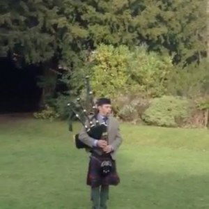 Playing the bagpipes during the wedding photographs Royal Marines Piper Piper Review Wedding Worcestershire