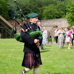 Piping from the pre party to the church Royal Marines Piper Piper Review Wedding Shropshire