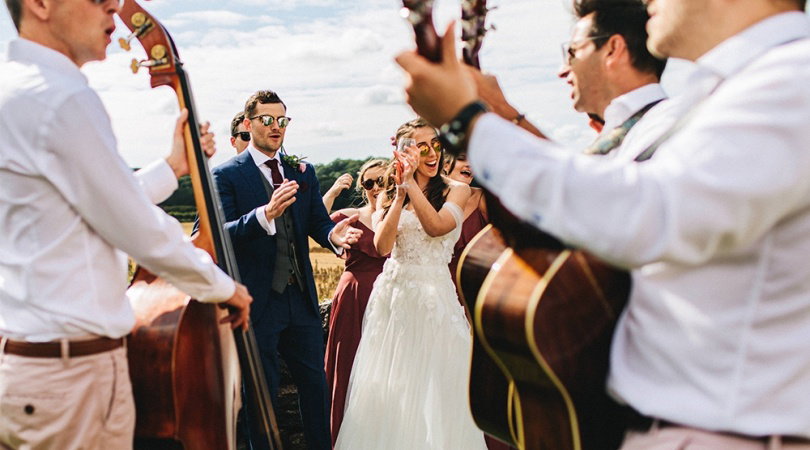 Live wedding band performing during a daytime wedding drinks reception