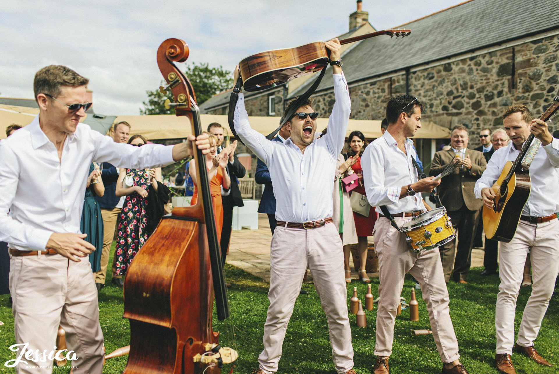 Acoustic wedding band performing at an outdoor drinks reception