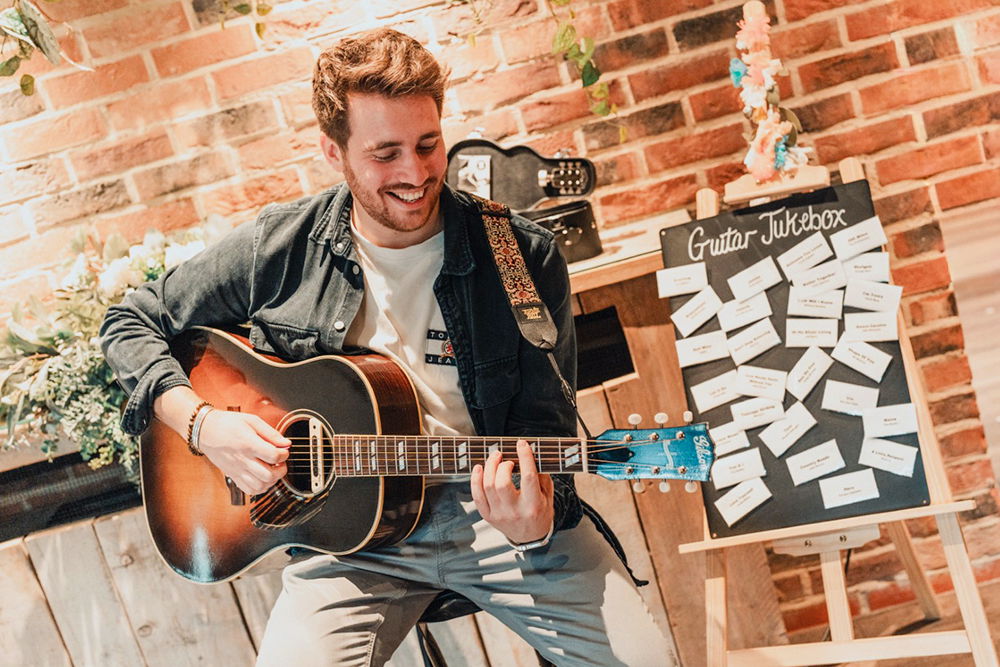 Guitarist performing acoustic wedding songs