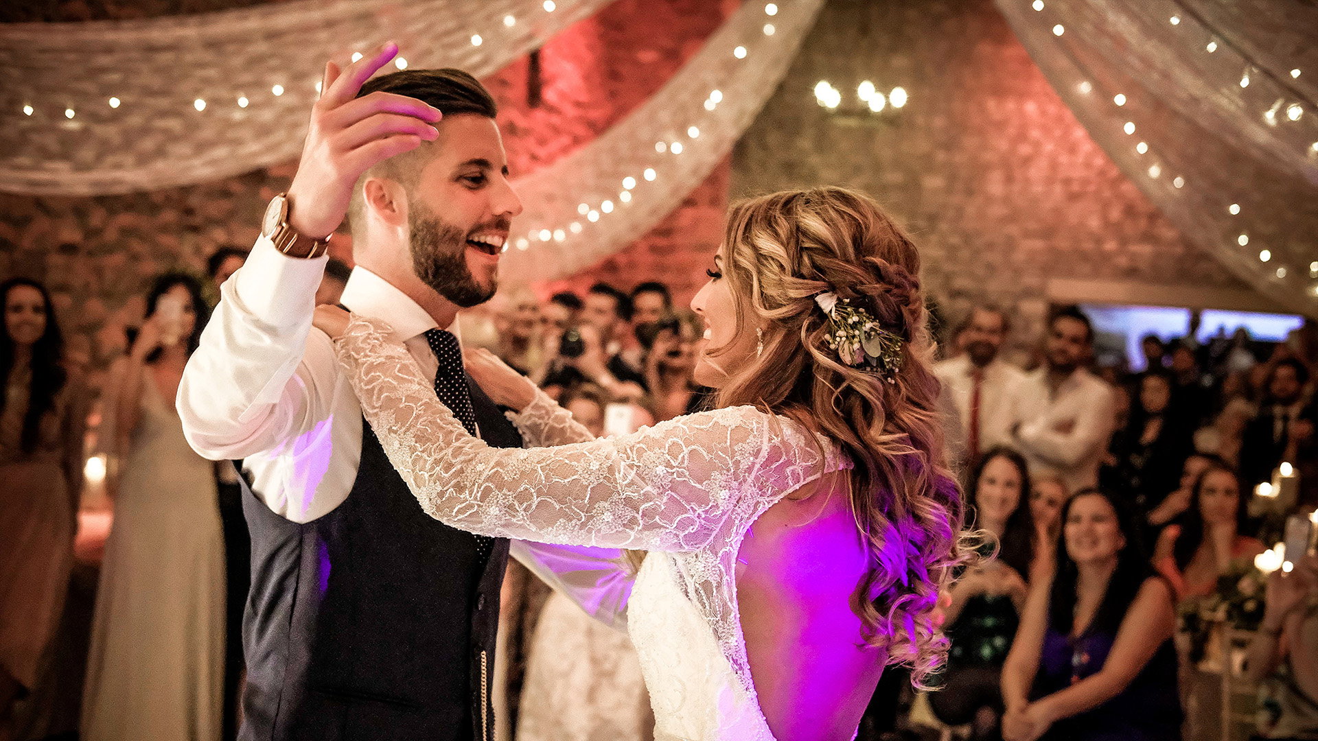 Couple sharing their first dance with a live wedding band performing at their reception