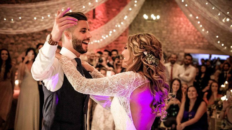 Couple sharing their first dance with a live wedding band performing at their reception