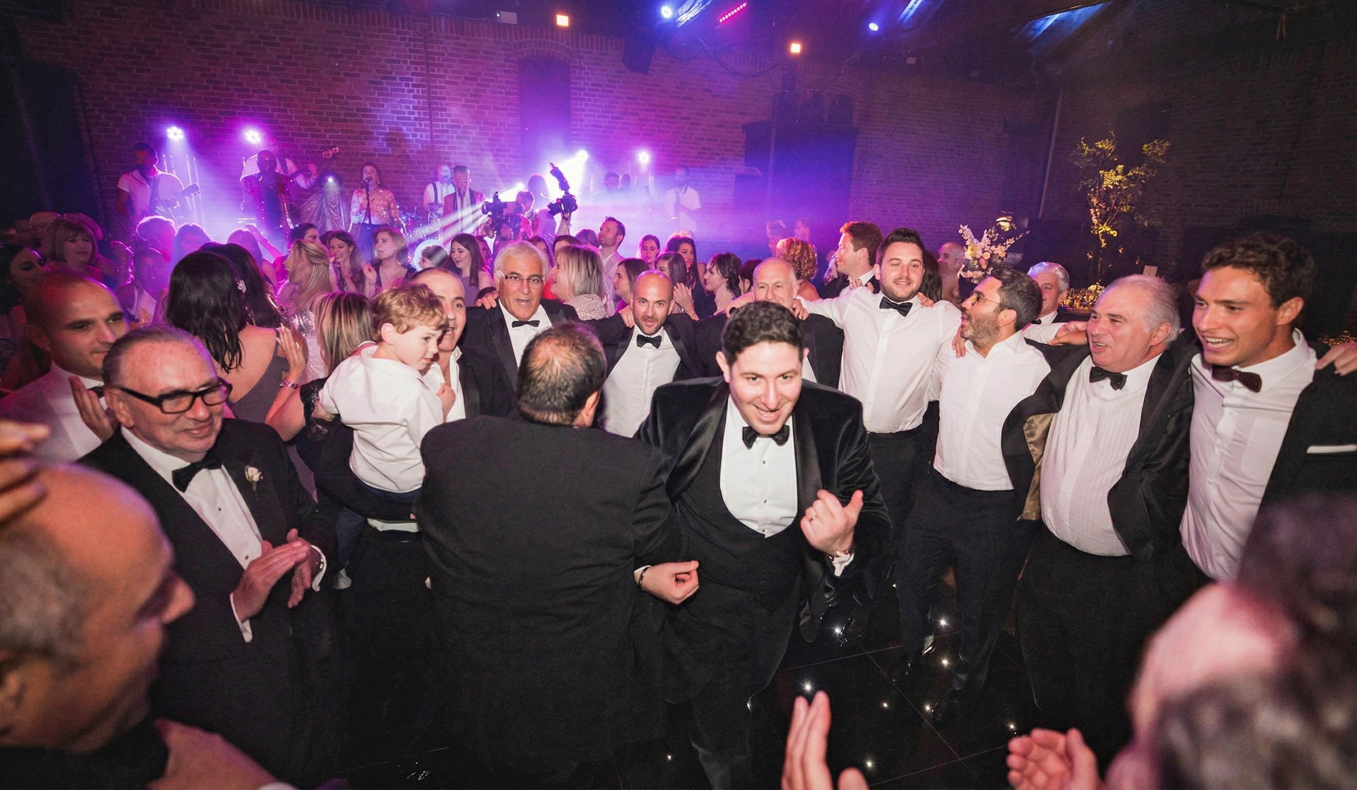 10 piece wedding band playing live to a dancing black tie wedding audience