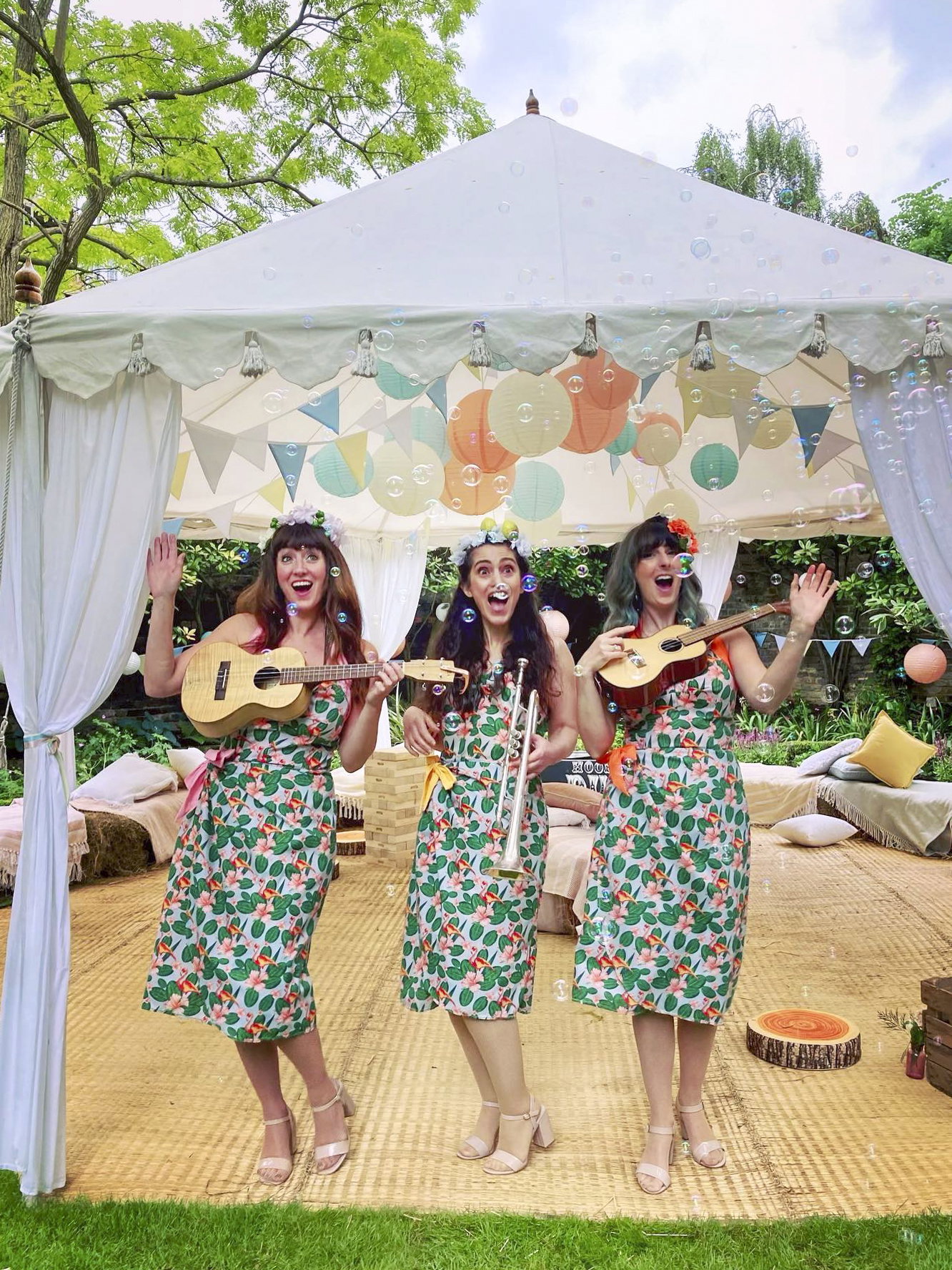 Acoustic wedding band set up under a covered outdoor stage with gazebo for protection
